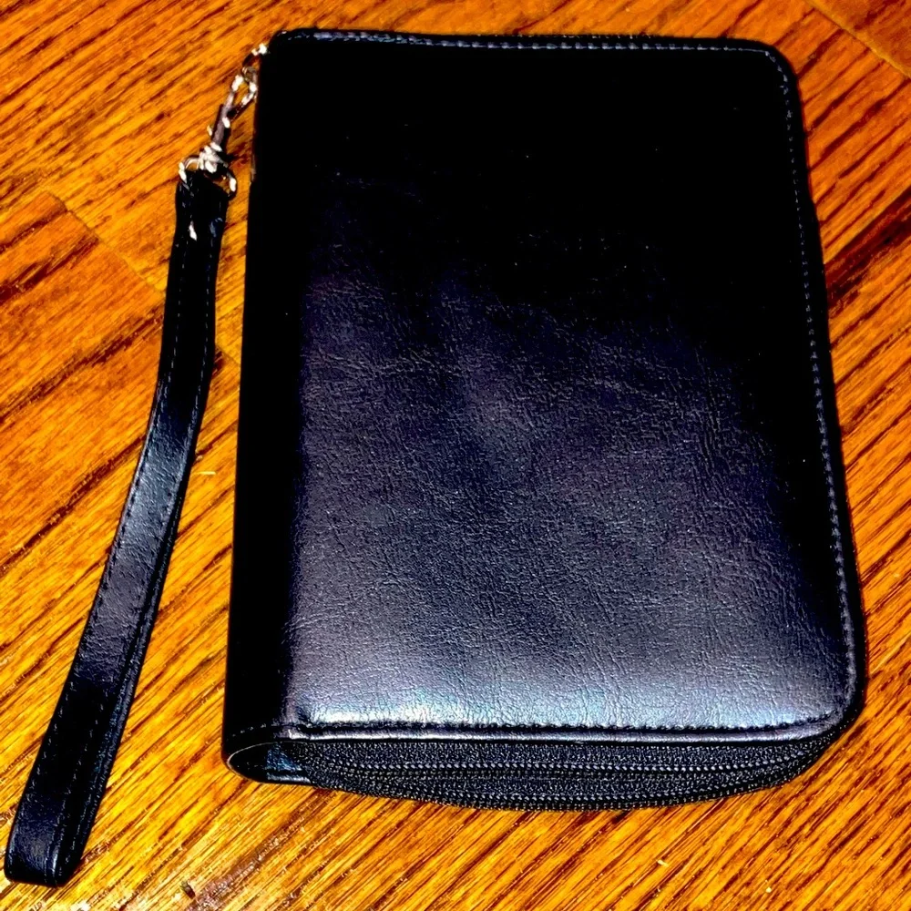 Black planner/organizer with zippered closure, wallet slot, addresses, goals